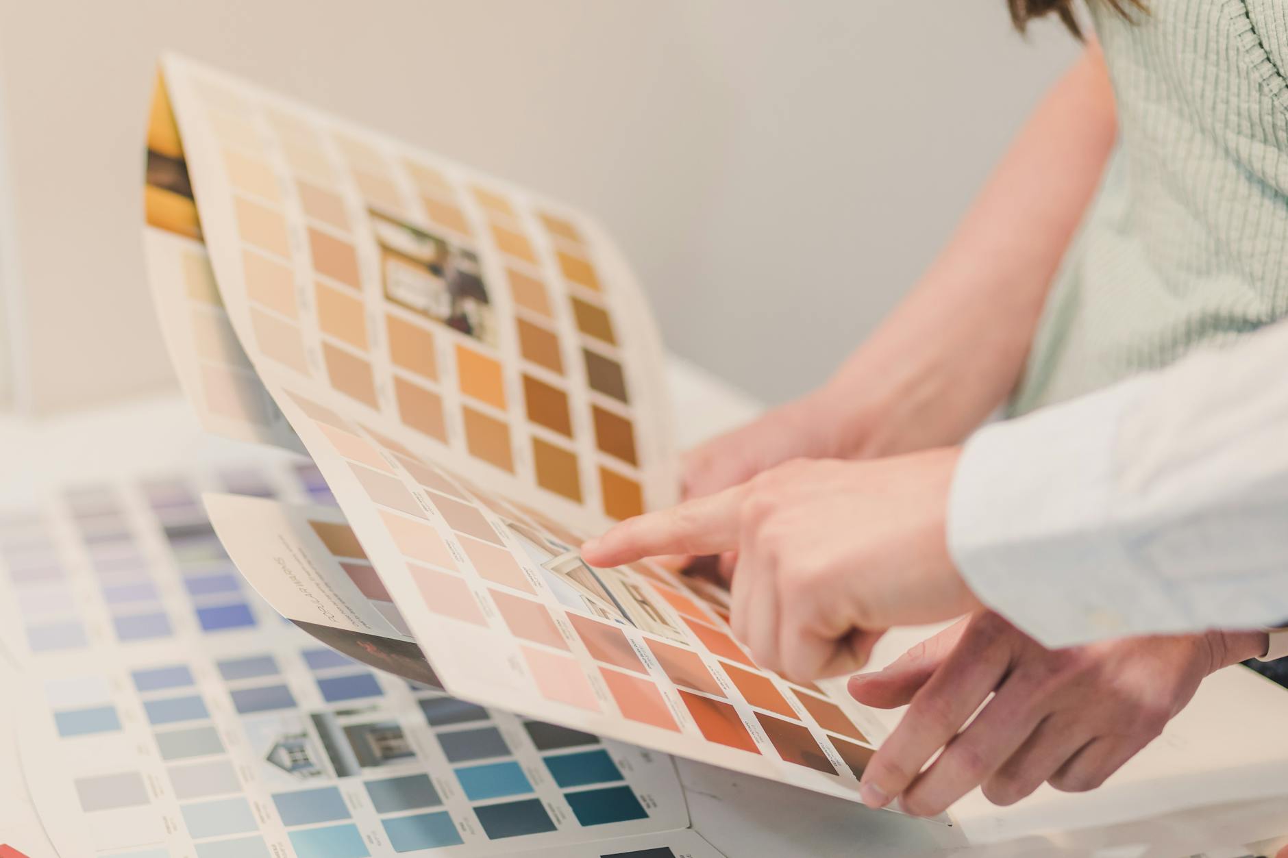 pexels-photo-8293676 - IFixSht Two people discussing and choosing color palettes for interior design projects.